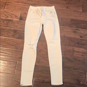 Knee-frayed ivory skinny jeans